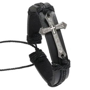Detail of black leather bracelet with braided rope and metal cross engraved with prayer