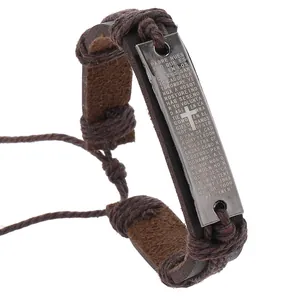 Detail of braided leather bracelet featuring engraved Spanish prayer and metal cross