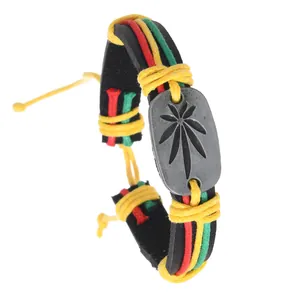 Macro shot of braided leather bracelet with tri-color cord and hemp leaf metal plate