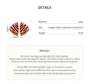 Detailed view of striped triangular earrings with precise 3.8cm length and material specs