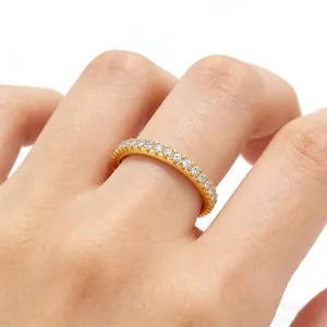 Detailed view of a gold S925 silver band ring with sparkling pavé cubic zirconia
