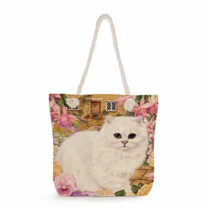 Detail of canvas tote with floral cat print and white thick cotton rope handles
