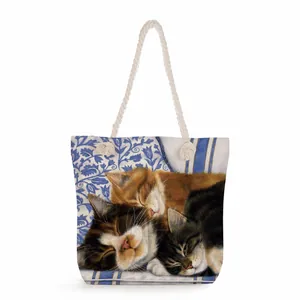 Detailed macro of the durable canvas texture and cat motif on the floral shoulder bag