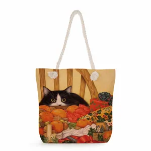 Detail of canvas tote bag with thick cotton rope handles and festive cat illustration