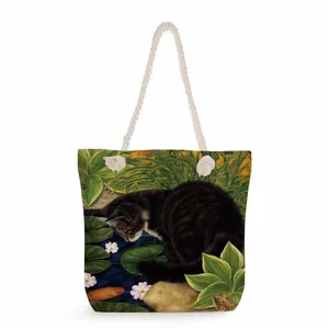 Detailed close-up of a canvas tote bag with black cat print and white rope handle