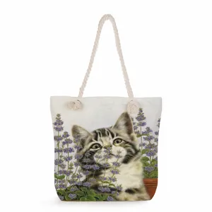 Close-up of canvas tote bag featuring cat and lavender print with cotton rope handles