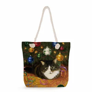 Detail of canvas tote bag showing thick cotton rope handles and cat Christmas print