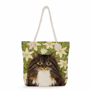 Detail of floral cat print tote bag featuring a white thick cotton rope handle