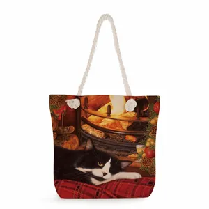 Detail of canvas tote bag with thick rope handles and festive cat fireplace print