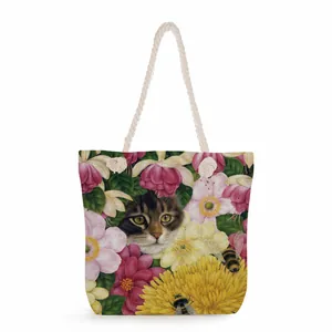 Detail of floral cat print on canvas beach bag with thick cotton rope handles