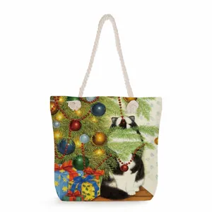 Detail of canvas tote bag featuring Christmas cat print and thick cotton rope handles