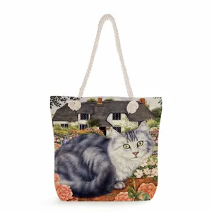 Detailed texture of cotton rope handle on floral cat canvas tote bag with garden scene