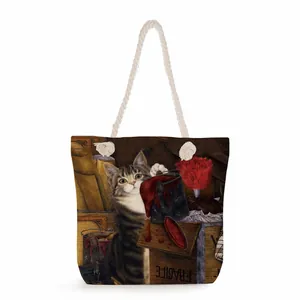 Detailed close-up of a canvas tote bag with thick cotton rope handles and vintage cat print