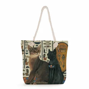 Detail of canvas tote bag featuring Egyptian cat print and thick rope handles