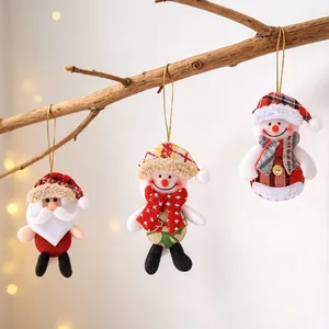 Detail of plush Santa and Snowman hanging ornaments with festive knitted patterns