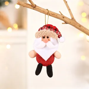 Close-up of a handmade Santa Claus plush ornament hanging on a rustic branch