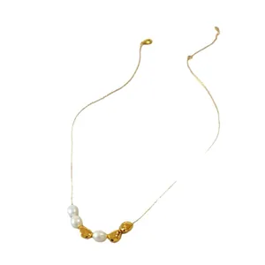 Baroque freshwater pearl and irregular gold bead necklace on a minimalist chain