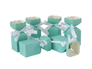 Close-up of mint green gift boxes featuring elegant petal edges and white satin ribbons