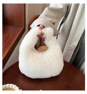 Close-up of fluffy white faux fur handbag on a wooden table with soft autumn aesthetic