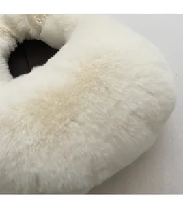 Detailed close-up of premium white faux fur fabric showing soft and fluffy texture