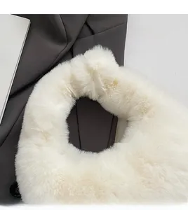 Detail of the soft white faux fur handle on a stylish winter plush handbag for women