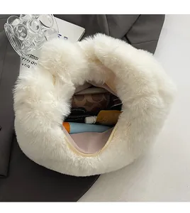 Spacious interior of white faux fur plush handbag showing capacity for daily essentials