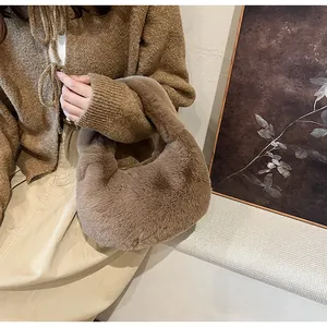 Detailed close-up of brown faux fur hobo bag with soft plush texture for winter