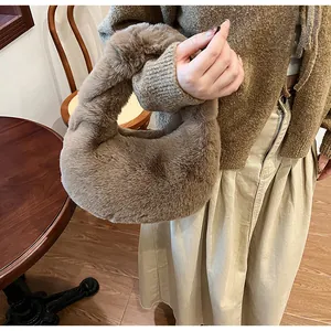 Detail of soft brown plush hobo bag showing thick faux fur texture and curved handle