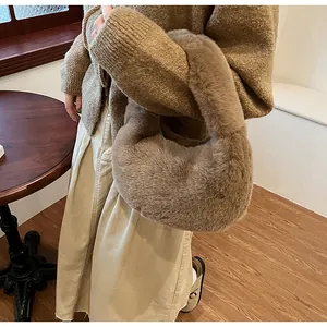 Close-up of fluffy khaki plush dumpling bag showing soft texture and integrated handle