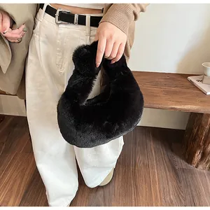 Close-up of a soft black plush dumpling bag featuring a cozy faux fur texture