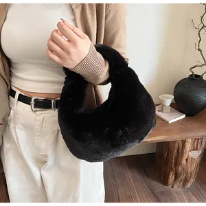 Close-up of premium black faux fur handbag with soft texture and minimalist handle