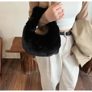 Detail of soft black plush handbag showing fluffy texture and integrated faux fur handle