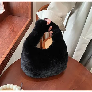 Detail of soft black faux fur texture on a stylish handheld dumpling bag for women