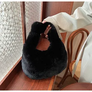 Close-up of fluffy black faux fur texture on the stylish handheld dumpling handbag