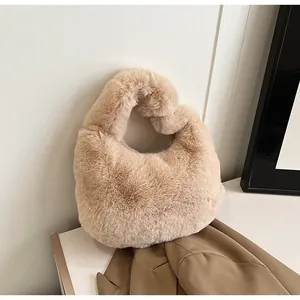 Close-up of soft beige faux fur texture on this trendy half-moon shape handbag