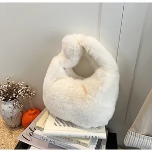Close-up of soft white faux fur handbag with a unique knot handle design for autumn