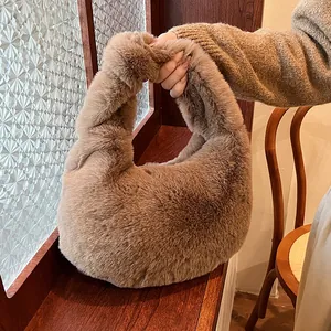 Brown faux fur knot handle handbag in half-moon shape for autumn and winter outfits