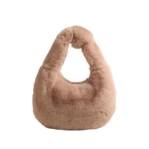 Pink faux fur dumpling handbag with plush handle and soft texture on white background