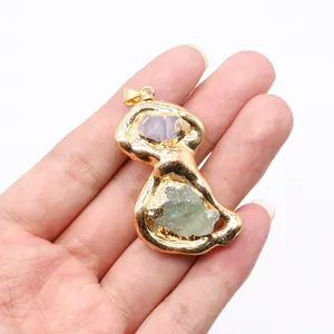 Detailed close-up of a golden female torso pendant with natural amethyst and green stones
