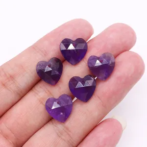 Detalle macro de cinco cuentas de amatista púrpura facetadas en forma de corazón para joyas