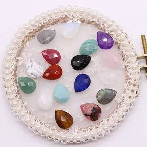 Faceted teardrop natural stone pendants for DIY necklaces shown on elegant white lace background
