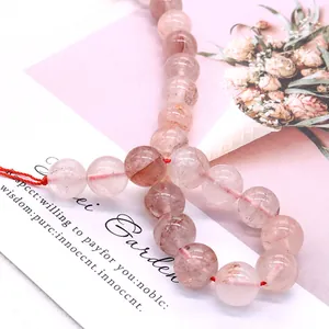 Polished natural pink strawberry quartz beads on a red elastic cord for DIY jewelry