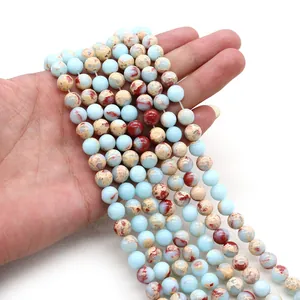 Detailed view of polished 8mm natural stone beads in mixed blue and rusty red tones