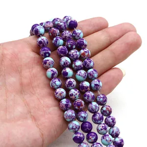 Detailed view of round imperial jasper beads in purple and light blue for DIY jewelry