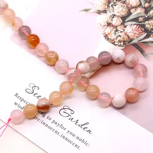 Polished natural cherry blossom agate round beads on a pink string for DIY jewelry