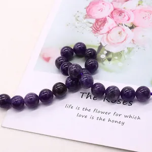 Polished natural purple amethyst round beads strand on a floral decorative card
