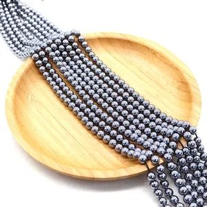 Deep grey terahertz hematite beads with metallic luster on wood tray for jewelry DIY