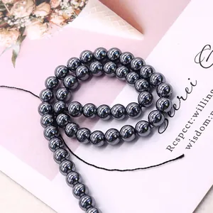 Polished metallic grey hematite round beads in a spiral layout for DIY jewelry making