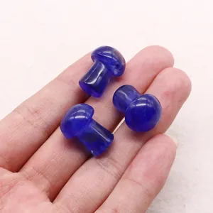 Close-up of three mushroom-shaped polished blue dragon blood stone beads held in hand