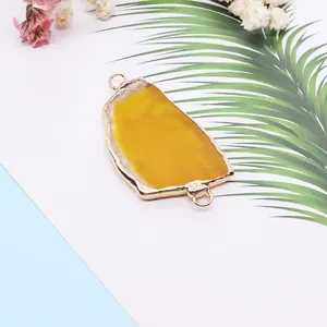 Irregular yellow natural agate slice pendant with gold plated edges and double rings